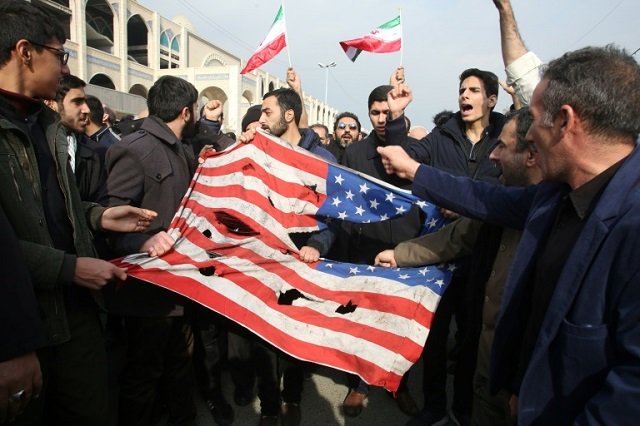 iranians tear up a us flag during a demonstration in tehran on january 3 2020 following the killing of iranian revolutionary guards major general qasem soleimani in a us strike in baghdad photo afp