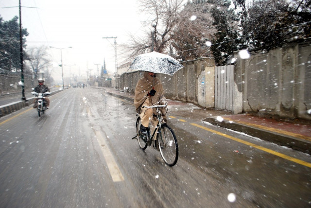 umbrellas come out as cold winds blow photo naseem james express umbrellas come out as cold winds blow photo naseem james express