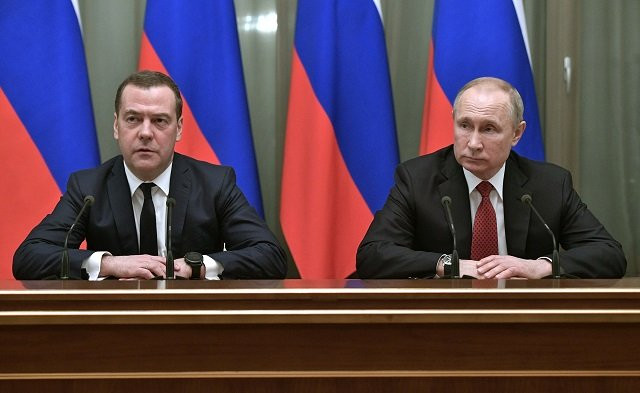russian president vladimir putin and prime minister dmitry medvedev meet with members of the government in moscow on january photo afp
