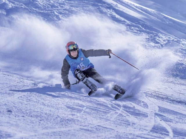 a skier slides downhill in a skiing competition in malam jabba photo express a skier slides downhill in a skiing competition in malam jabba photo express