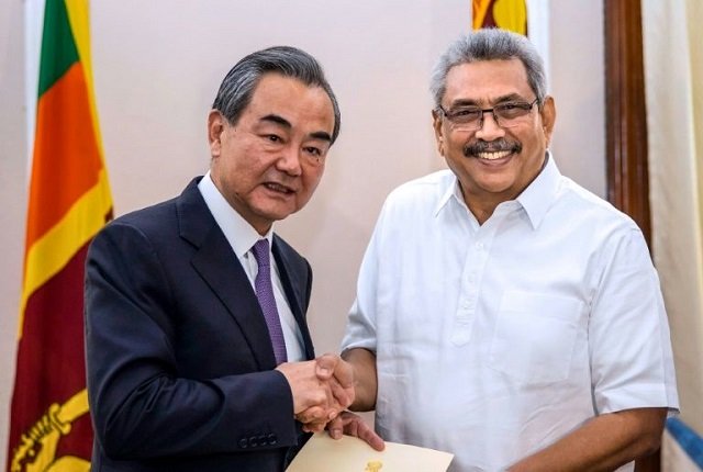 sri lankan president gotabaya rajapaksa shakes hands with chinese foreign minister wang yi during a meeting in colombo photo afp file