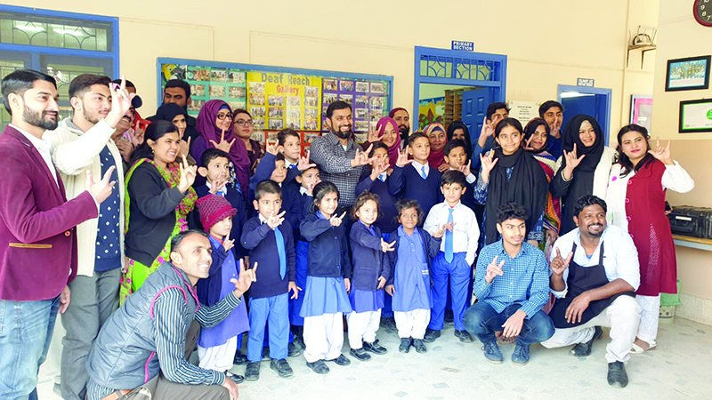 ovais iqbal celebrates his cisco global community hero award with children teachers and staff at the karachi campus of the deaf reach schools who he believes are most deserving of the honour photo courtesy ovais iqbal