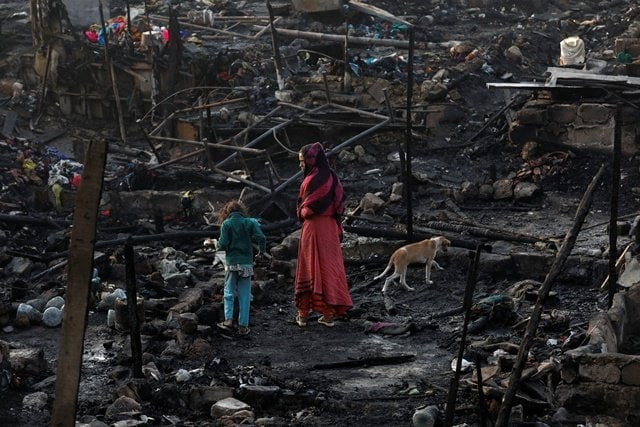 siblings with their pet dog search for belongings as they visit the burnt out house of their family after a fire broke out in a slum in karachi reuters siblings with their pet dog search for belongings as they visit the burnt out house of their family after a fire broke out in a slum in karachi reuters