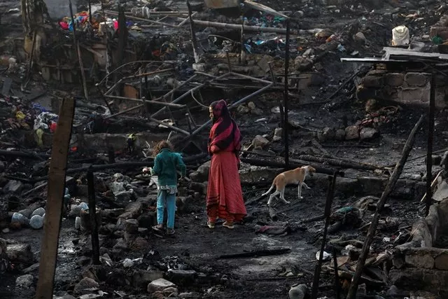siblings with their pet dog search for belongings as they visit the burnt out house of their family after a fire broke out in a slum in karachi reuters siblings with their pet dog search for belongings as they visit the burnt out house of their family after a fire broke out in a slum in karachi reuters