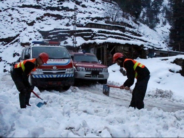 rescue workers clear a snow covered road to make way for an ambulance to reach the areas affected by heavy snowfall and avalanches in neelum valley photo reuters file