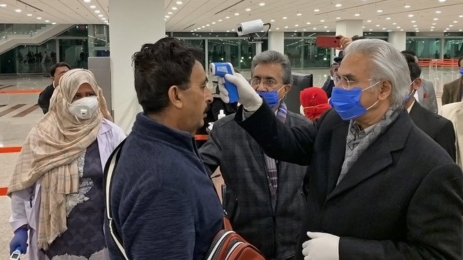 state minister for health zafar mirza inspects passengers at the islamabad international airport on january 25 2020 following an outbreak of the coronavirus in china photo zafar mirza twitter