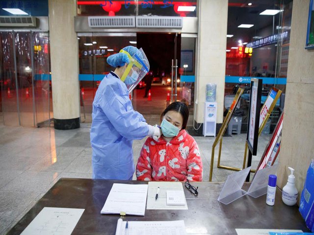 a nurse takes the temperature of a woman in the reception area of the first people 039 s hospital in yueyang hunan province near the border to hubei province which is under partial lockdown after an outbreak of a new coronavirus in china january 28 2020 photo reuters