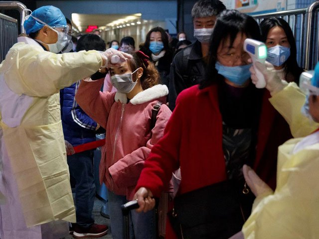 medical workers take the temperature of passengers after they got off the train in jiujiang jiangxi province china as the country is hit by an outbreak of a new coronavirus january 29 2020 photo reuters