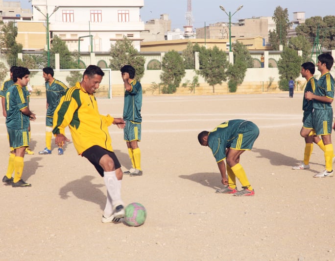 azad baloch fc owner jihand shaukat ali practises with his team in the lyari football ground photo express