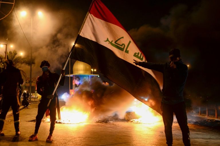 iraqi president names new pm dividing protesters