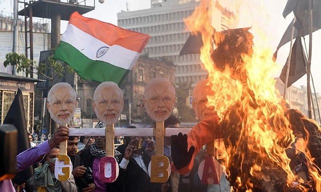 activists burn masks with the face of india 039 s prime minister narendra modi at a protest against india 039 s new citizenship law in kolkata on january 11 2020 photo afp