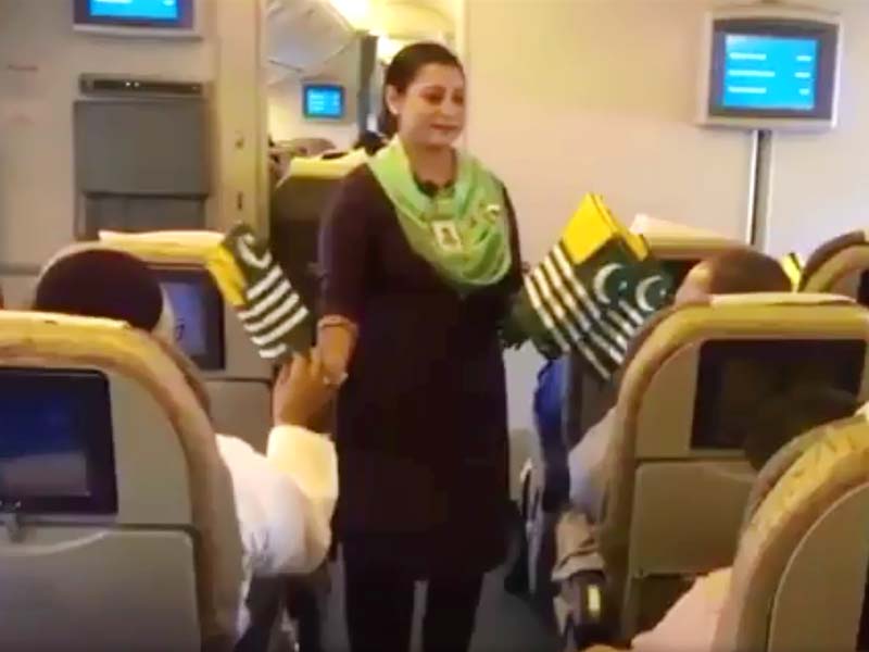 cabin crew members announce special message hand out kashmiri flags to passengers in flight screengrab twitter piaofficial