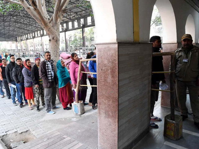 people queue up to cast their votes for delhi assembly elections at a polling station in new delhi on february 8 2020 photo afp people queue up to cast their votes for delhi assembly elections at a polling station in new delhi on february 8 2020 photo afp
