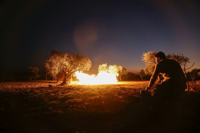 a syrian rebel fires a rocket towards regime forces positions in the southern countryside of aleppo photo afp