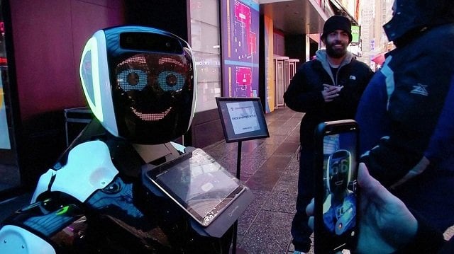 passers by in times square interact with a promobot robot that informs the public about the symptoms of coronavirus and how to prevent it from spreading in this still frame obtained from video in new york city us february 10 2020 photo reuters