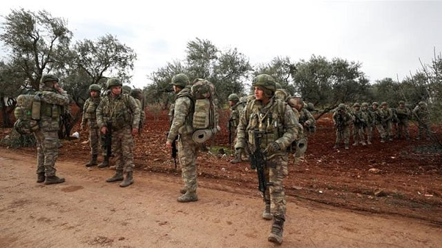 turkish soldiers gather in the village of qaminas about six kilometres southeast of idlib city in northwestern syria photo afp turkish soldiers gather in the village of qaminas about six kilometres southeast of idlib city in northwestern syria photo afp