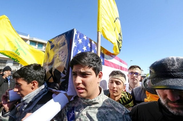 iranians carry a mock coffin bearing the colors of the us flag during commemorations marking 41 years since the islamic revolution in the capital tehran 039 s azadi square on february 11 photo afp