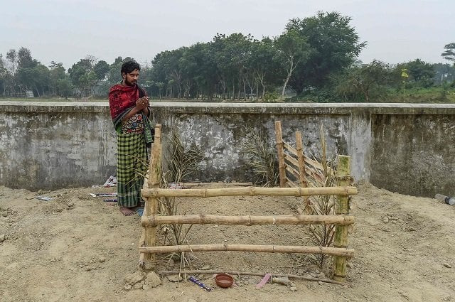 this photo shows mukul seikh praying in front of the grave of his mother former sex worker hamida begum in daulatdia in rajbari district photo afp this photo shows mukul seikh praying in front of the grave of his mother former sex worker hamida begum in daulatdia in rajbari district photo afp
