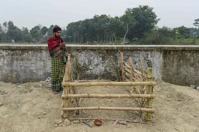 this photo shows mukul seikh praying in front of the grave of his mother former sex worker hamida begum in daulatdia in rajbari district photo afp this photo shows mukul seikh praying in front of the grave of his mother former sex worker hamida begum in daulatdia in rajbari district photo afp