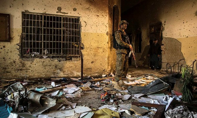 an army soldier stands inside the army public school which was attacked by taliban gunmen in peshawar photo reuters an army soldier stands inside the army public school which was attacked by taliban gunmen in peshawar photo reuters