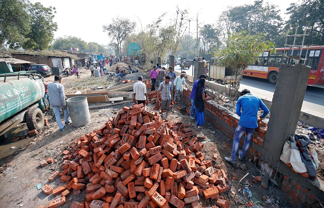 construction workers build a wall along a slum area as part of a beautification drive along a route that us president donald trump and india 039 s prime minister narendra modi will be taking during trump 039 s visit later this month in ahmedabad india february 13 2020 photo reuters