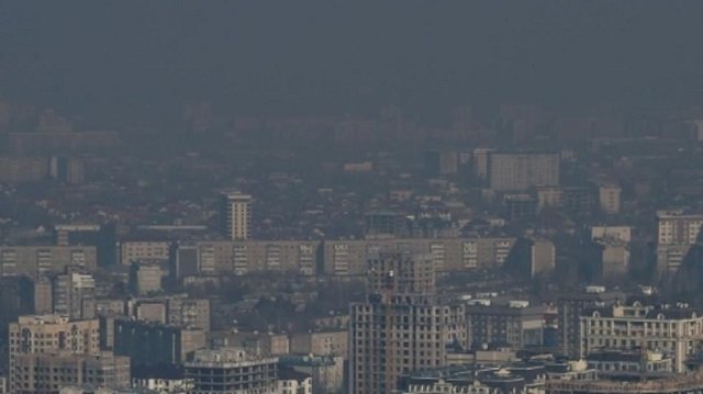 a heavy cloud of dark smog often blots out the view of snow capped mountains in the kyrgyz capital of bishkek photo afp