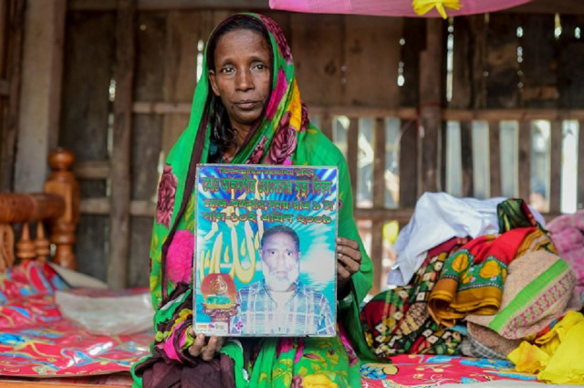 bangladeshi mother of four mosammat rashida whose husband was killed by a bengal tiger a decade ago while he was collecting honey holds a portrait of her husband during an interview with afp at her house in shyamnagar photo afp bangladeshi mother of four mosammat rashida whose husband was killed by a bengal tiger a decade ago while he was collecting honey holds a portrait of her husband during an interview with afp at her house in shyamnagar photo afp