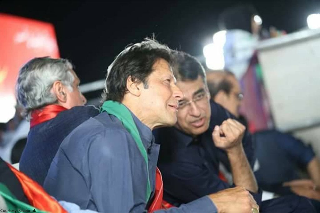 a file photo of imran khan as he listen to asad umar with jahangir tareen sitting at the back photo pti