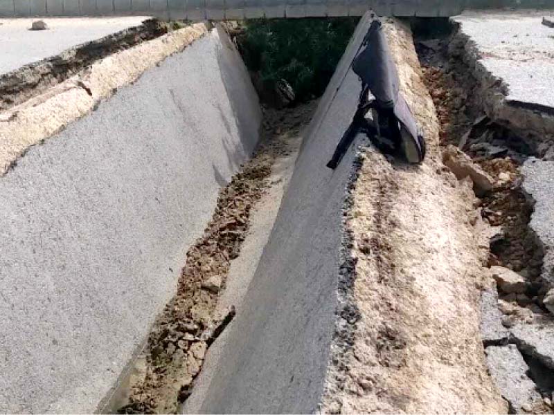 a gutter gapes open across the road in safoora goth after the slabs covering it crumbled in the rain the road where a terror attack took place in 2015 was repaired with much fanfare only four years ago photo express