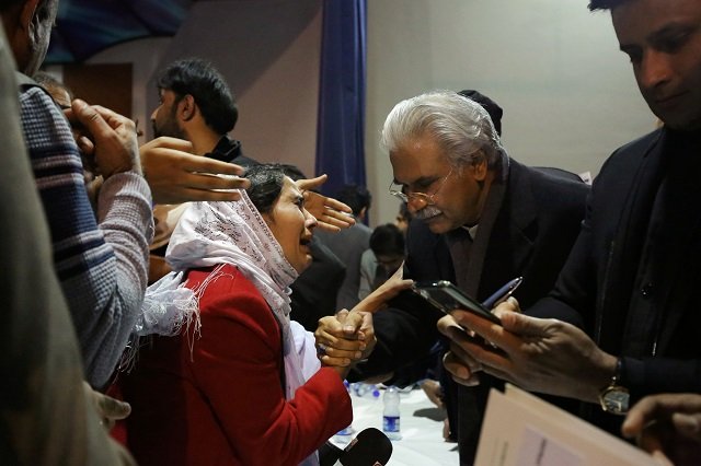 dr zafar mirza r interacts with the mother of a pakistani student who is stuck in the locked down hubei province at the center of china 039 s coronavirus outbreak as people demand evacuation of their children during a meeting in islamabad pakistan february 19 2020 photo reuters