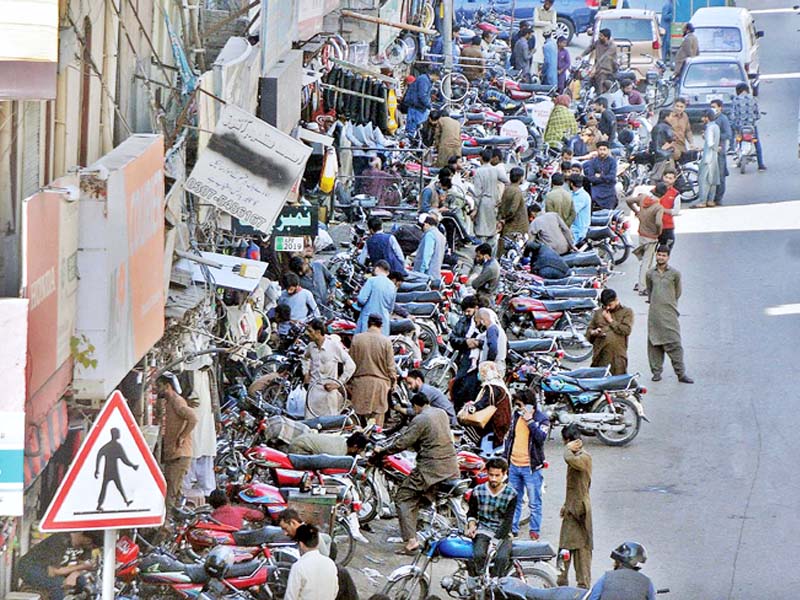 parking two wheelers on sidewalks is a common practice in rawalpindi s commercial areas which forces pedestrians to risk their lives by walking on busy thoroughfares photo nni