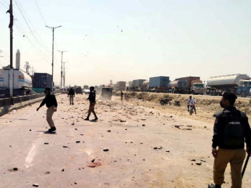 policemen fire teargas shells to disperse protestors riots erupted at multiple locations in karachi on tuesday photo ppi