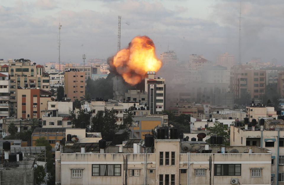 Smoke and flames are seen following an Israeli air strike on a building, amid a flare-up of Israeli-Palestinian fighting, in Gaza City May 18, 2021. PHOTO: REUTERS