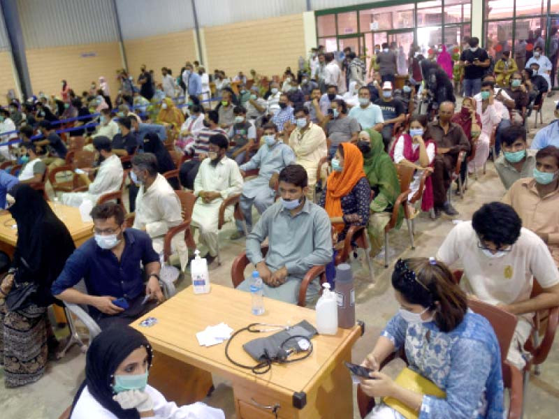 people wait for their turn to receive the coronavirus vaccine at the expo centre on thursday photo afp