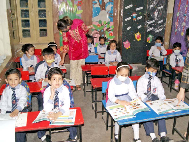 children attend a class at a government school photo online