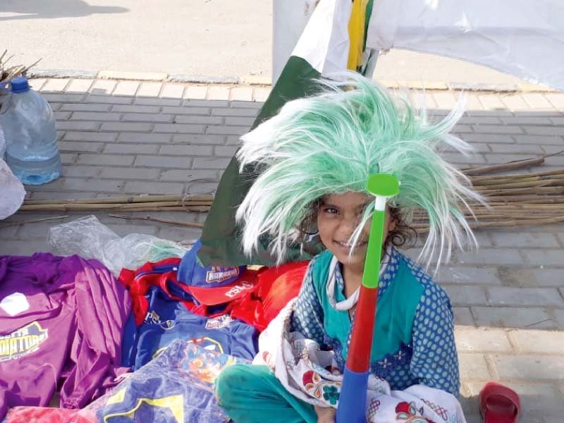 young iqra sells flags cricket jerseys vuvuzelas and wigs near the national stadium photo express