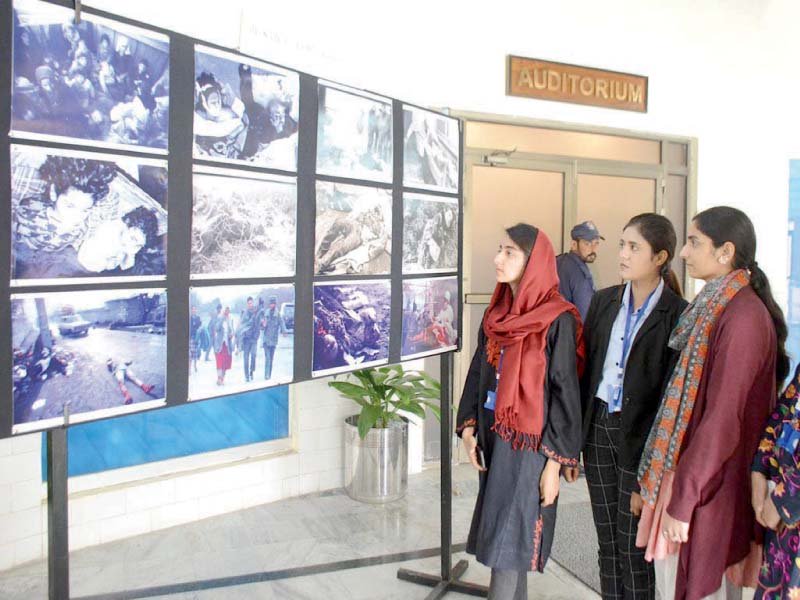 numl students show interest in photographs at a seminar highlighting the tragedy of genocide and ethnic cleansing photo dna