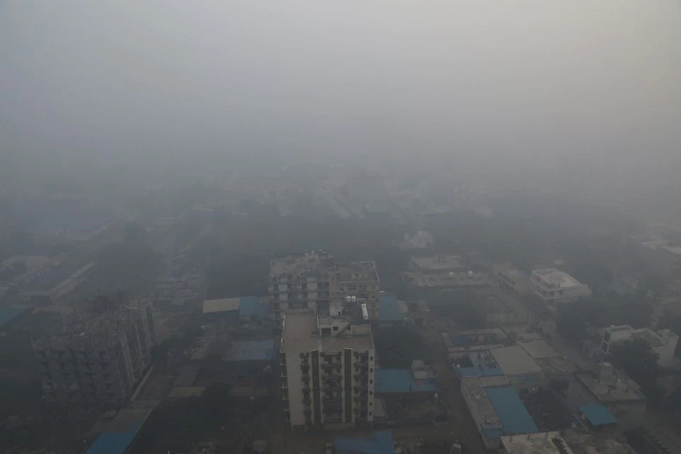 Residential buildings are seen shrouded in smog in Noida, India, November 5, 2021. REUTERS