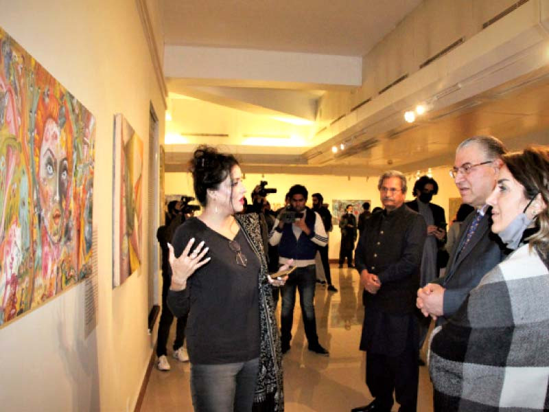 ayisha arshad shahnawaz explains the intricacies of her artwork to visitors at her painting exhibition at pnca photo express