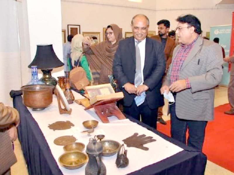 people are moving around at the venue of the cultural programmes impressed by the diversity offered while a participant is seen displaying her handicraft skills photo express