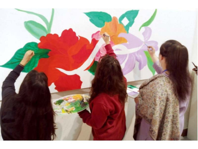 visitors view noor muqaddam s calligraphy while some women make a painting of her name in her memory photos zafar raja express visitors view noor muqaddam s calligraphy while some women make a painting of her name in her memory photos zafar raja express