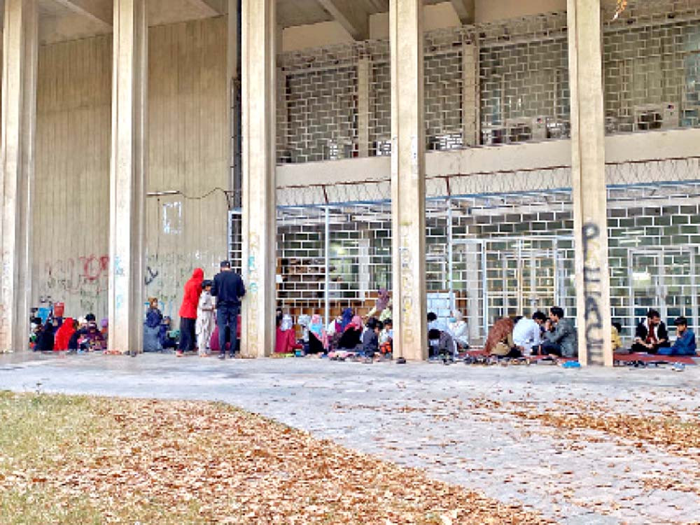 Children revise their daily lessons while others sit with their instructors at a student-led tutoring service at Quaid-e-Azam University, Islamabad. PHOTOs: EXPRESS