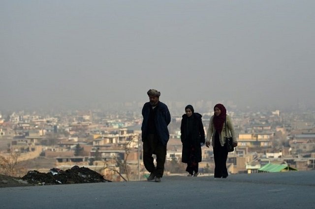 afghans walks on a hillside overlooking kabul after the partial truce was announced photo afp file