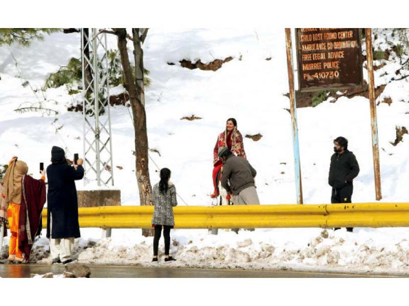 tourists enjoy a bright day out in murree as the snow lies sparkling in the sunlight photo app file