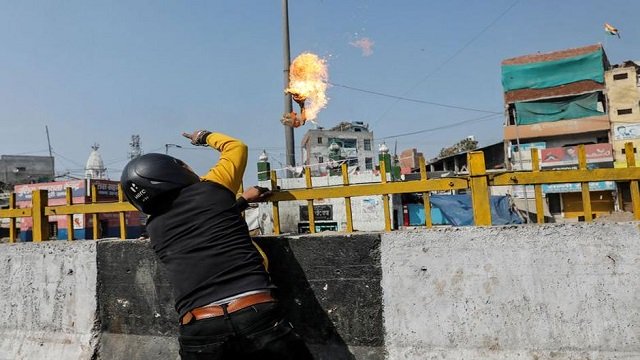 a man from hindutva mob supporting the new citizenship law throws a petrol bomb at a muslim shrine during a clash with those opposing the law in new delhi february 24 photo reuters