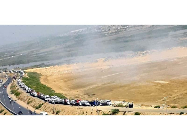garbage trucks line up to dump trash at the malir riverbed residents of the area claim that the waste is regularly burned at the site photo express garbage trucks line up to dump trash at the malir riverbed residents of the area claim that the waste is regularly burned at the site photo express