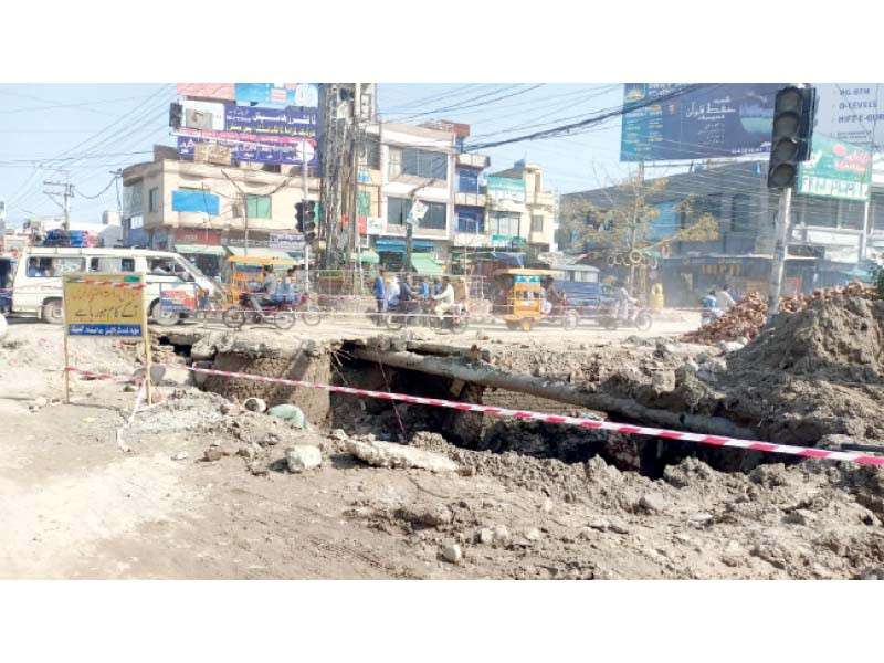 motorists navigate around the dug up roads of gujarat the incomplete sewerage project and open crevasses in the road pose danger to citizens photo express