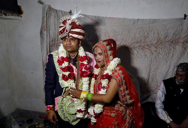 savitri prasad 23 and her husband gulshan pose after taking their wedding vows inside savitri 039 s parents 039 house in a riot affected area following clashes between people demonstrating for and against a new citizenship law in new delhi india