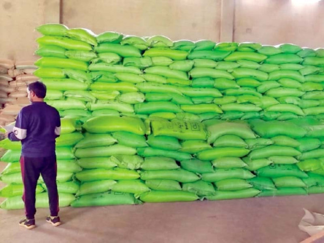 a government official inspects fertiliser bags stacked up at a warehouse photo express a government official inspects fertiliser bags stacked up at a warehouse photo express