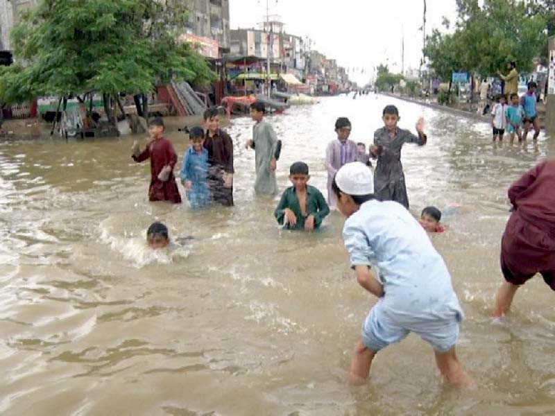 children play in water overflowing from thadu and lath dams in kda scheme 33 photo express